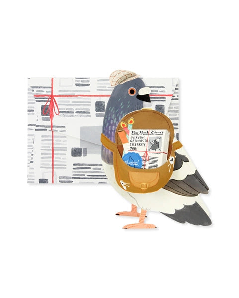 A pop-up card illustration featuring a 3D pigeon with an open pouch revealing a 'Poo York Times' newspaper headline.