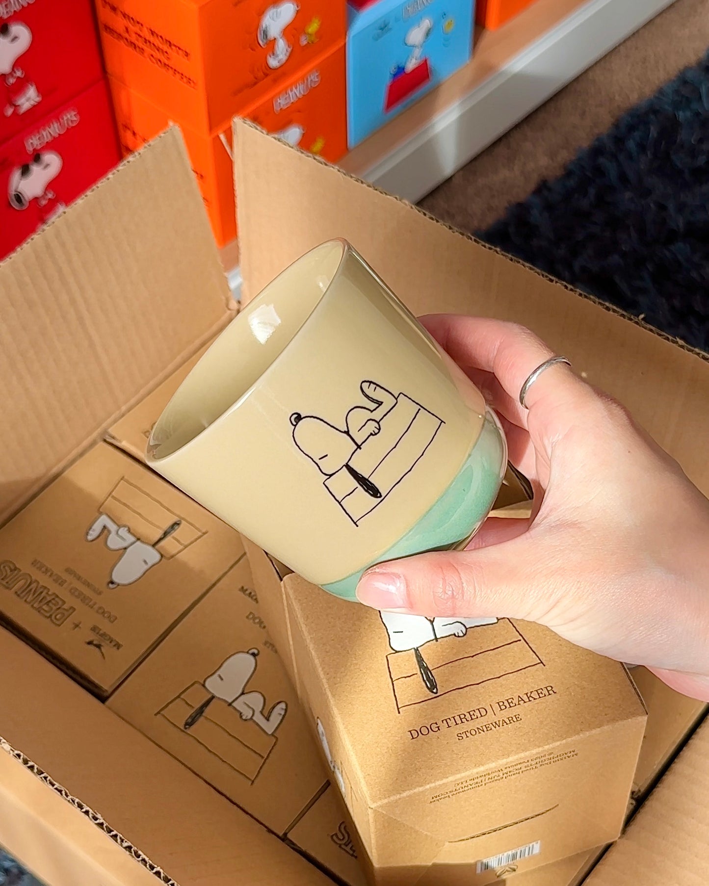 Official Snoopy “Dog Tired” stoneware mug with minimalist line-art and reactive glaze, packaged in a kraft Peanuts® gift box