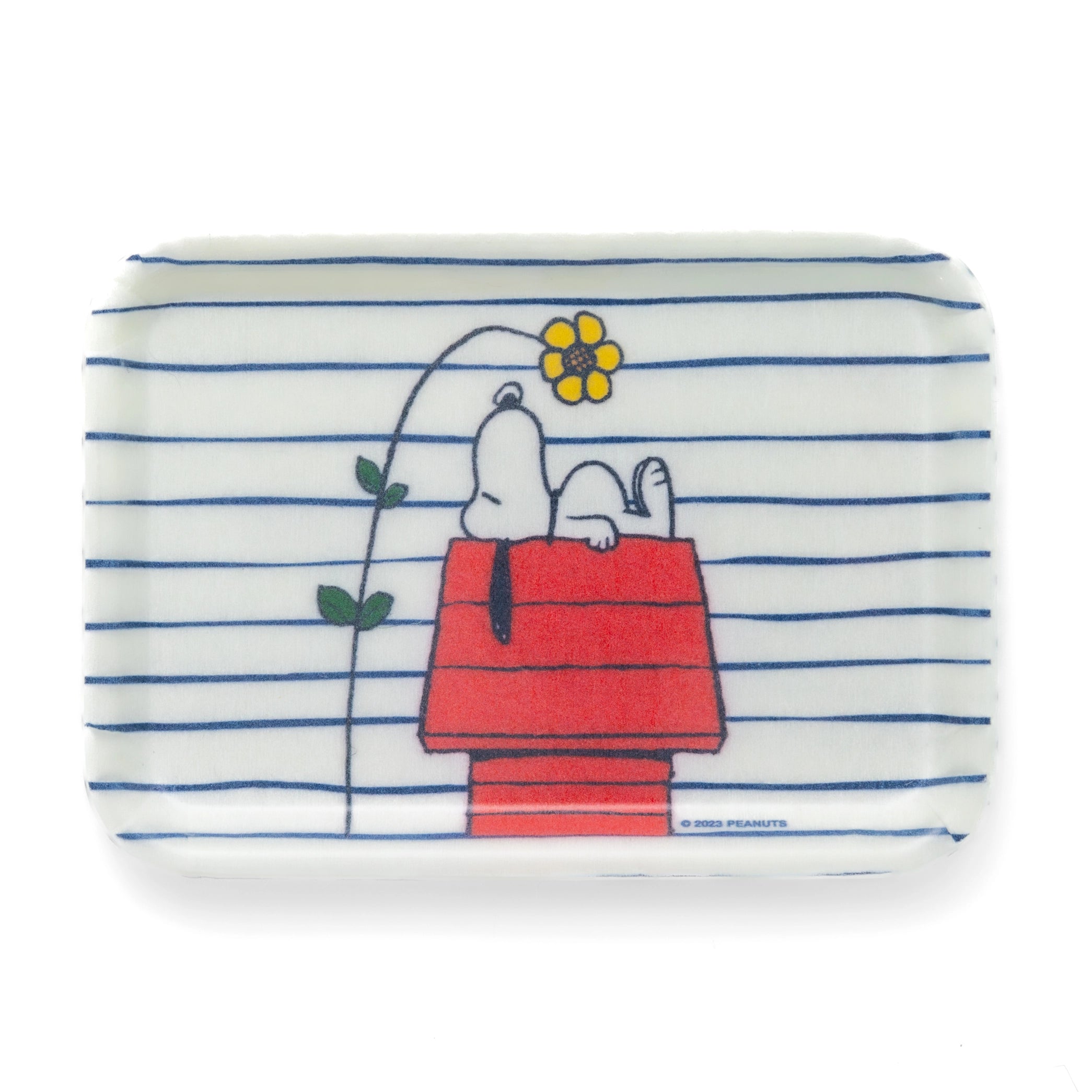 Rectangular fiberglass tray with Snoopy lounging on his red doghouse beneath a flower, set against blue and white stripes. A charming and functional Peanuts catchall for home, office, or entryway use.
