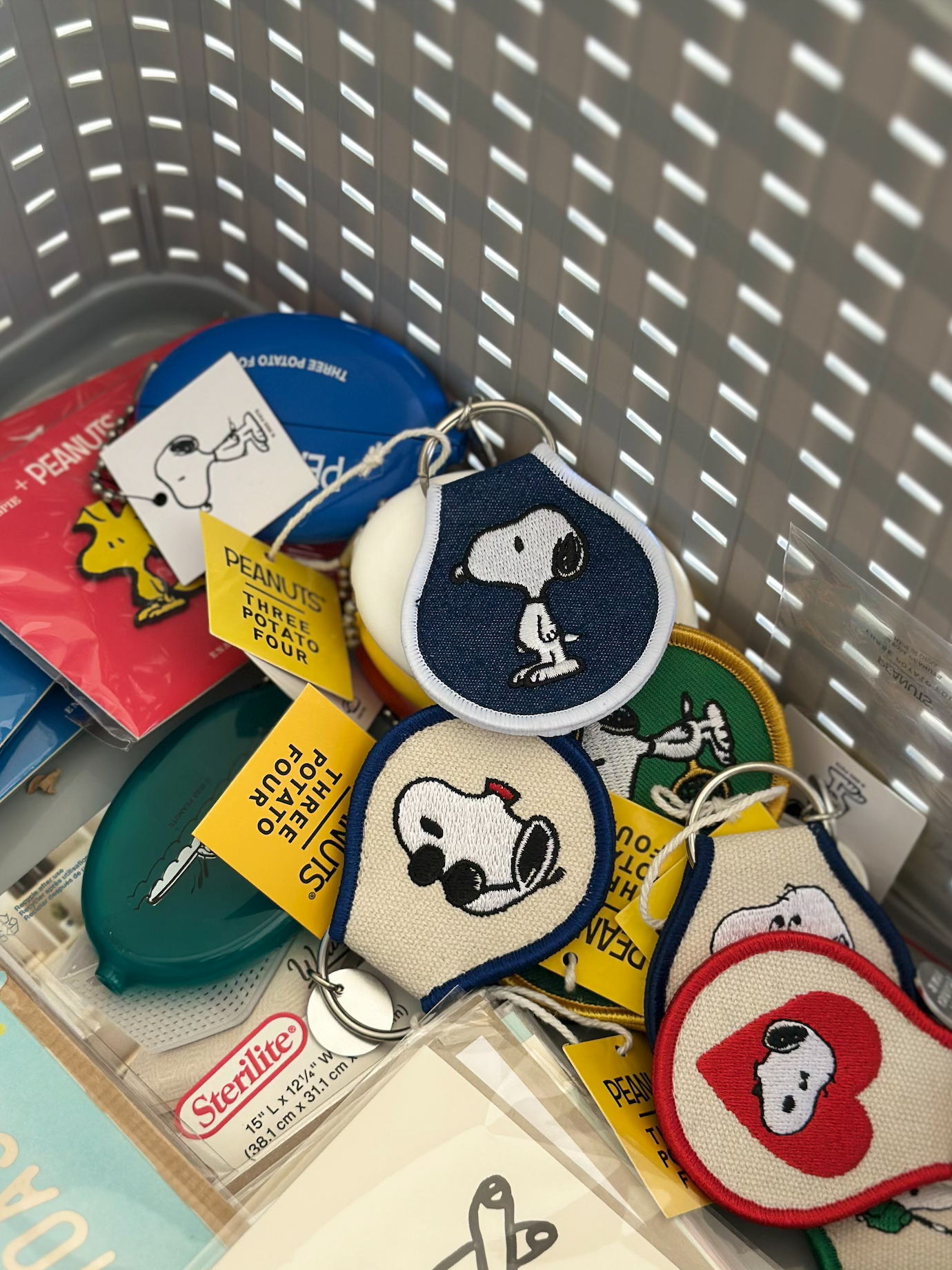 Collection of embroidered Snoopy keychains featuring multiple designs including sunglasses, doghouse, tennis, and heart motifs.