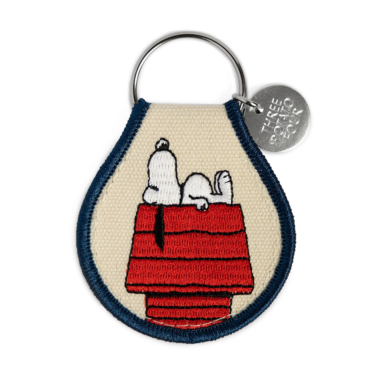 Snoopy embroidered keychain napping on red doghouse – front view, Peanuts official merch