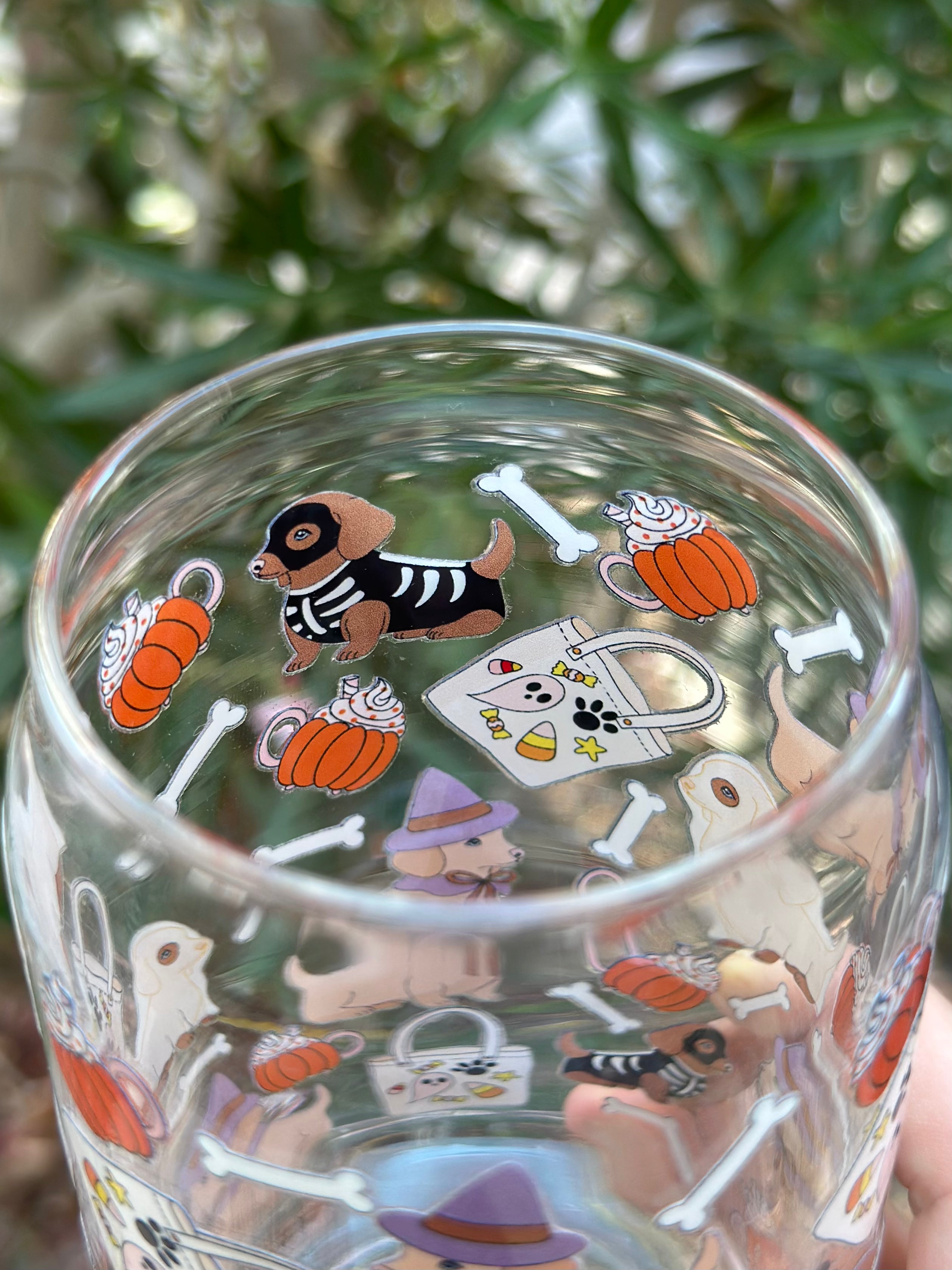 Inside top view of dachshund Halloween glass can cup showing skeleton dachshund, pumpkin mugs, tote bags, and white bones.