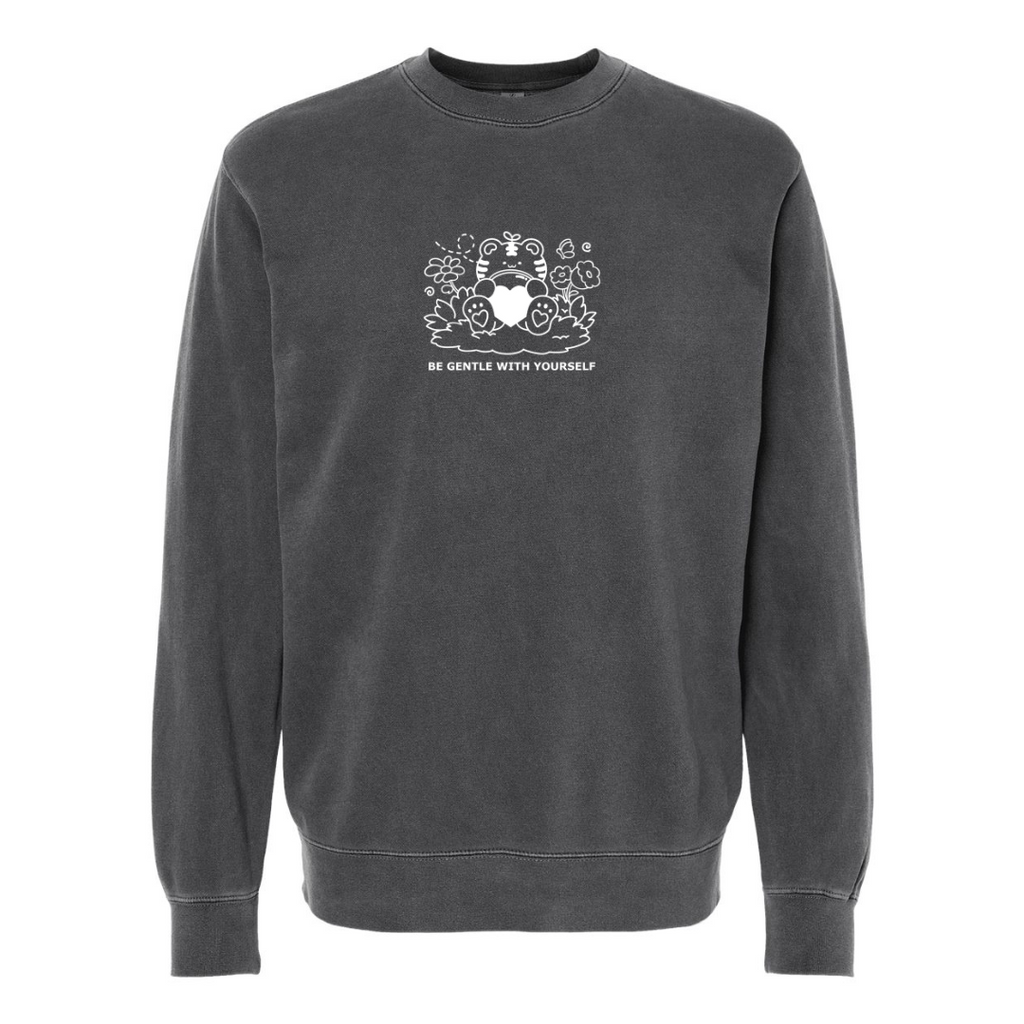 Charcoal gray crewneck sweatshirt featuring subtle white embroidery of a gentle character holding a heart with the words “Be Gentle With Yourself” on the front.