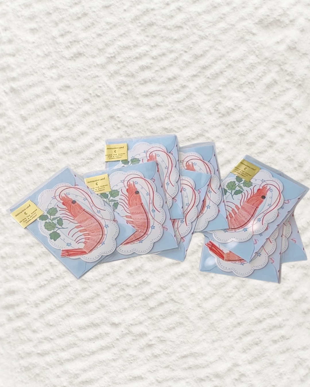 Interactive seafood-themed pun card with shrimp peel design