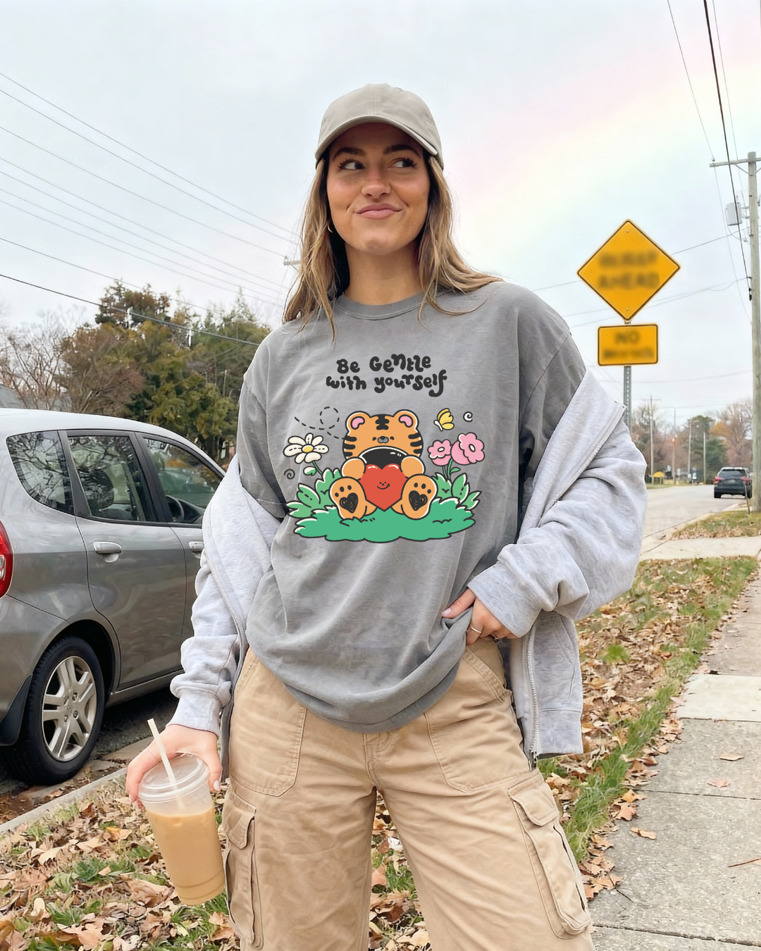 Woman wearing a charcoal gray “be gentle with yourself” graphic tee styled casually for an everyday outfit