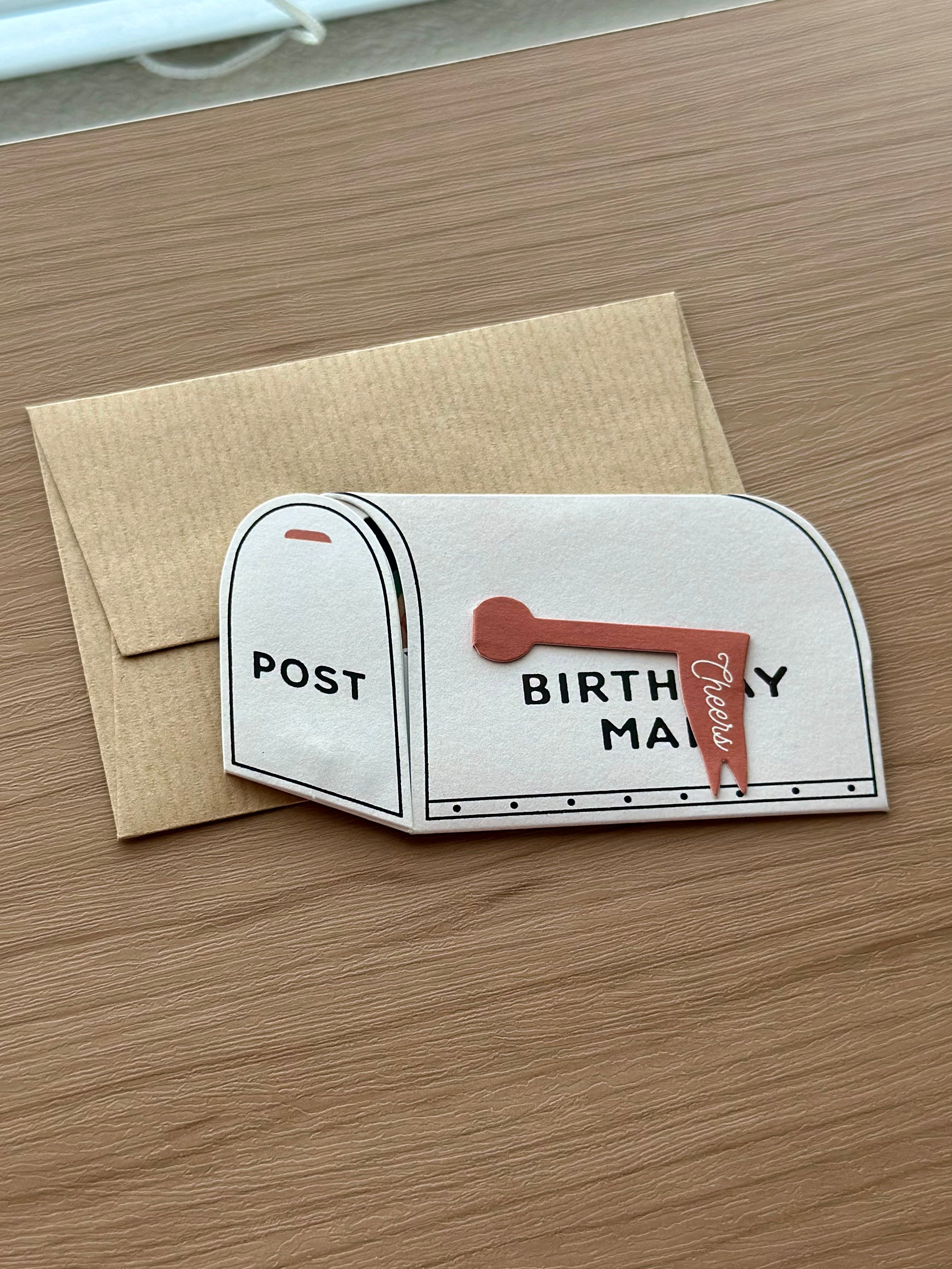 Birthday mailbox pop-up greeting card with kraft envelope, front message “Birthday Mail” and “Cheers” flag.