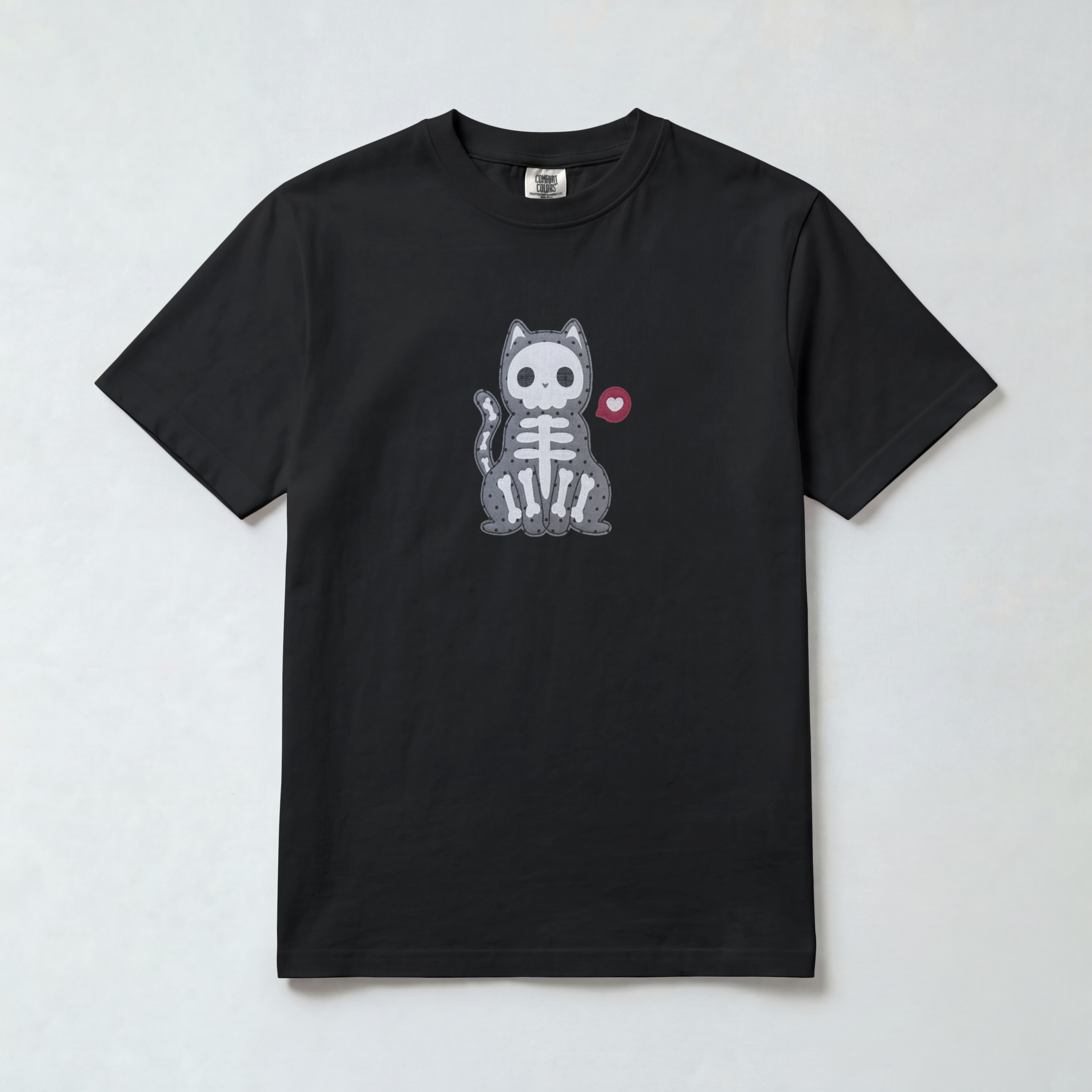 A black short-sleeve crewneck t-shirt featuring a central graphic of a gray and white pixelated cat skeleton with a small red heart on its ear, displayed flat against a light gray background.