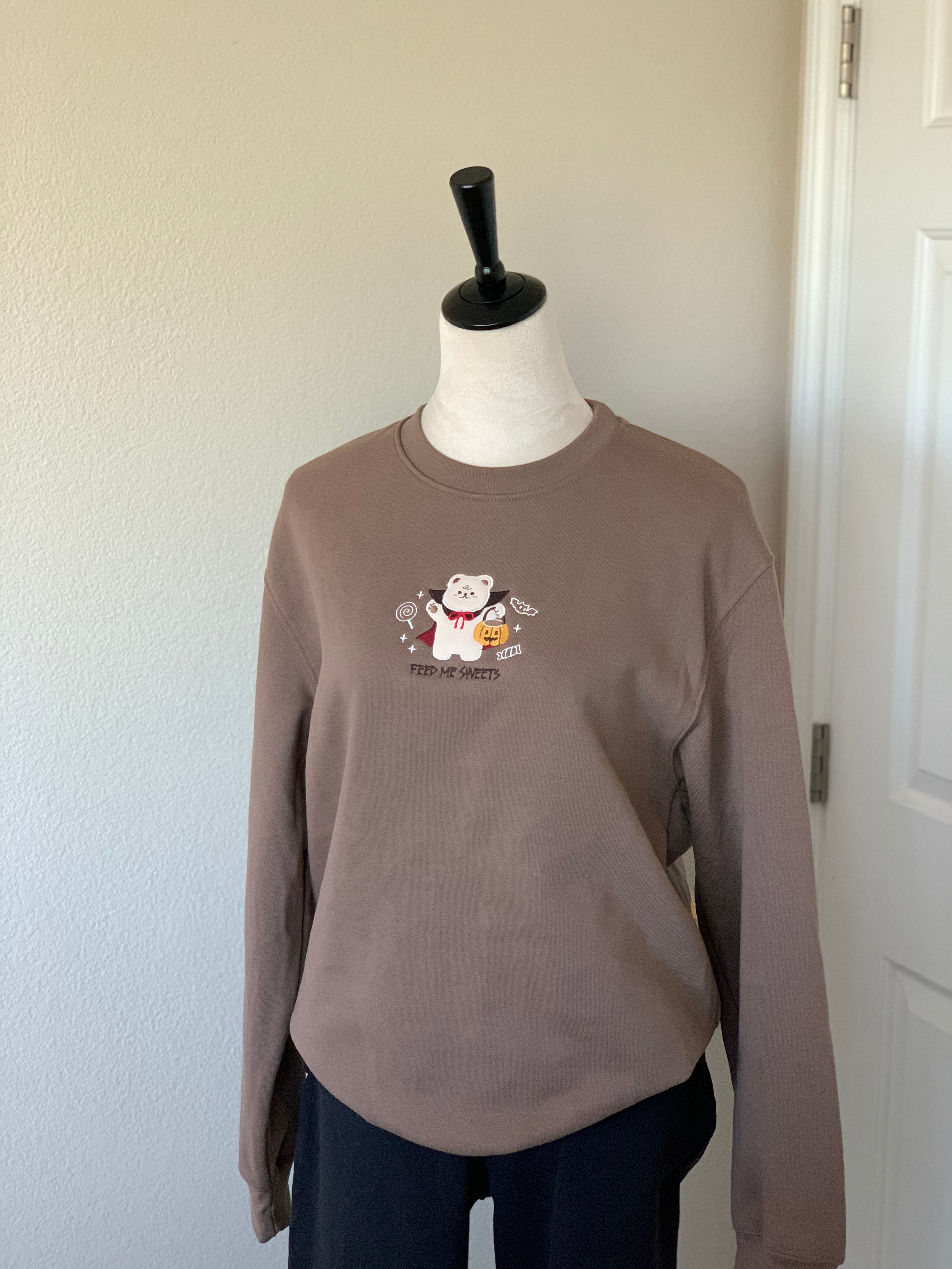 Full brown sweatshirt displayed on mannequin with embroidered vampire bear and “Feed Me Sweets” text.