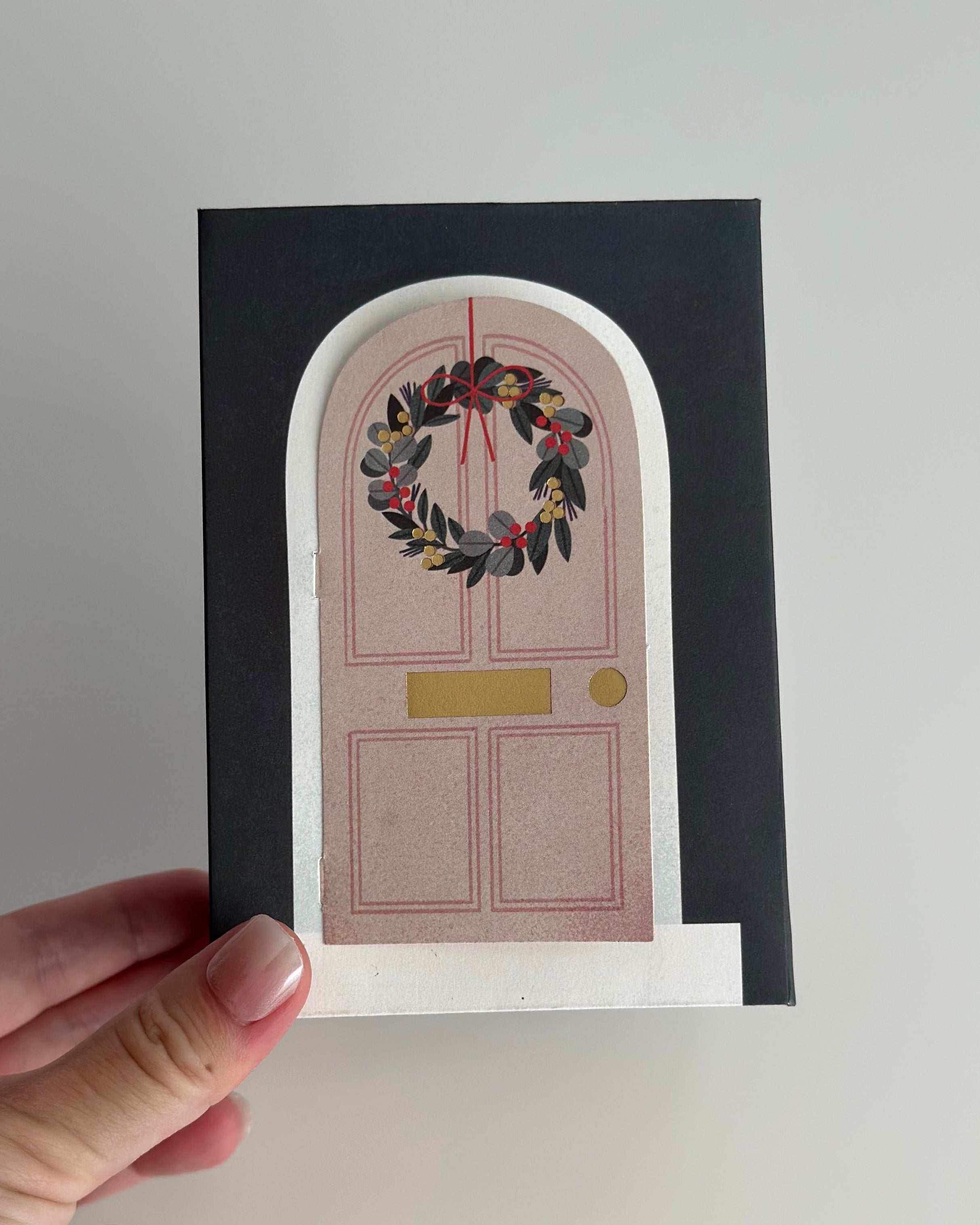 Overhead view into pop-up Christmas room showing layered tree, fireplace, wall art, and gifts.