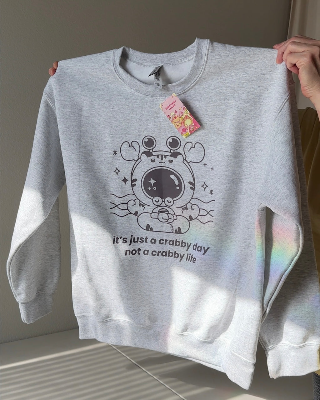 Crabby Day comfort crewneck with Overthinker Apparel hang tag – soft gray sweatshirt with emotional support message and cozy burnout recovery vibe