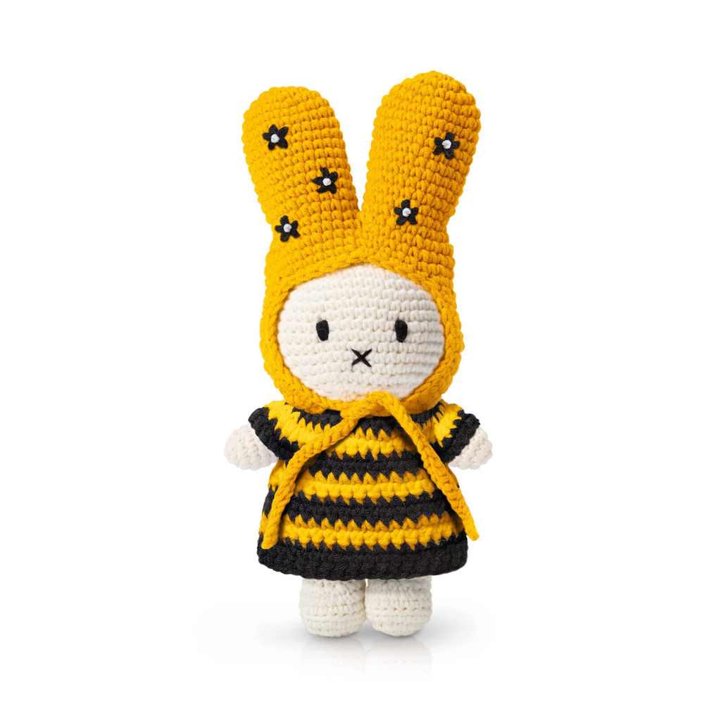 Handmade crochet bunny doll dressed in a bee-inspired outfit with yellow and black stripes and embroidered flowers on the ears — a playful plush toy full of spring charm.
