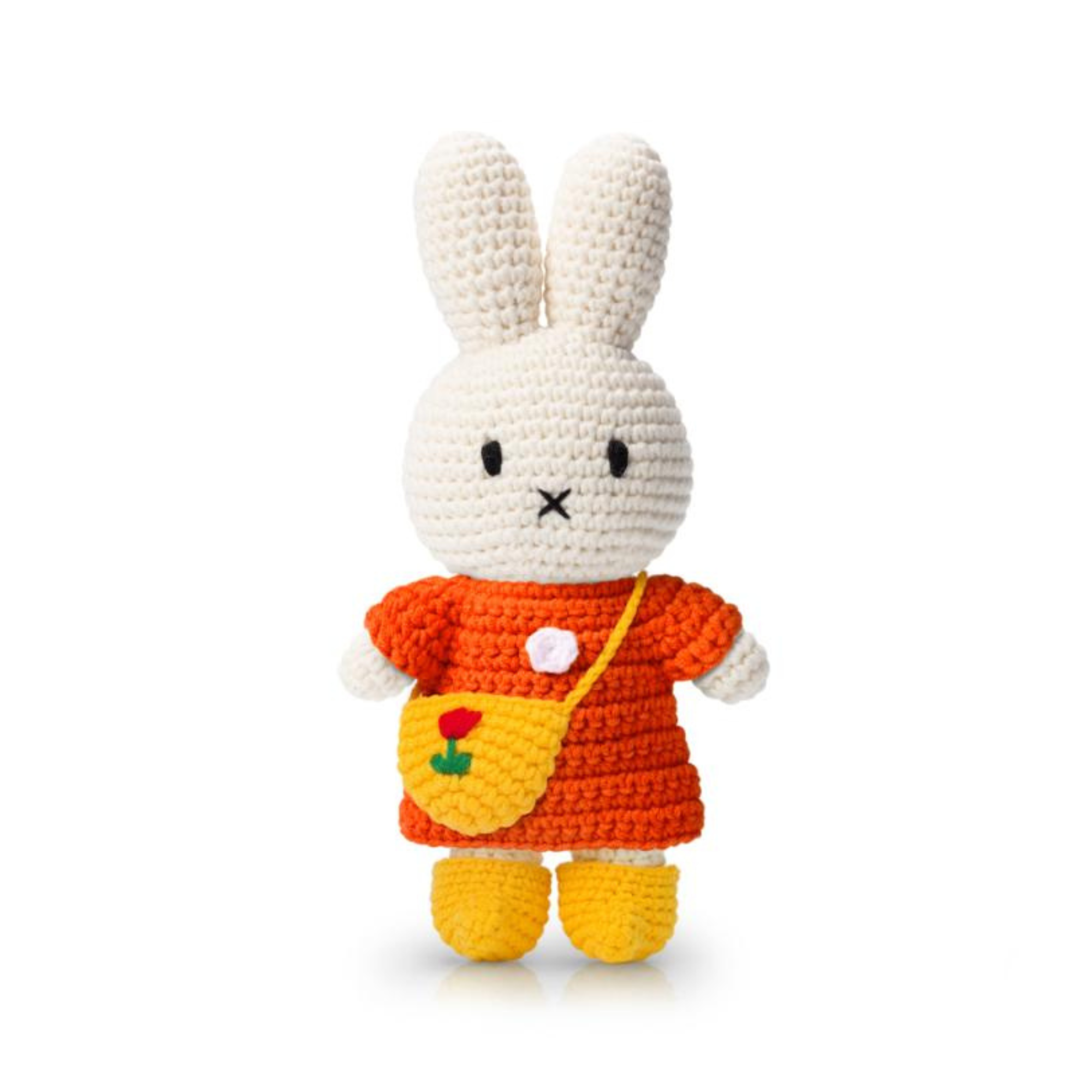 Crochet bunny doll wearing an orange dress, yellow booties, and a tiny tulip-embroidered crossbody bag — a charming handmade plush full of cozy detail.