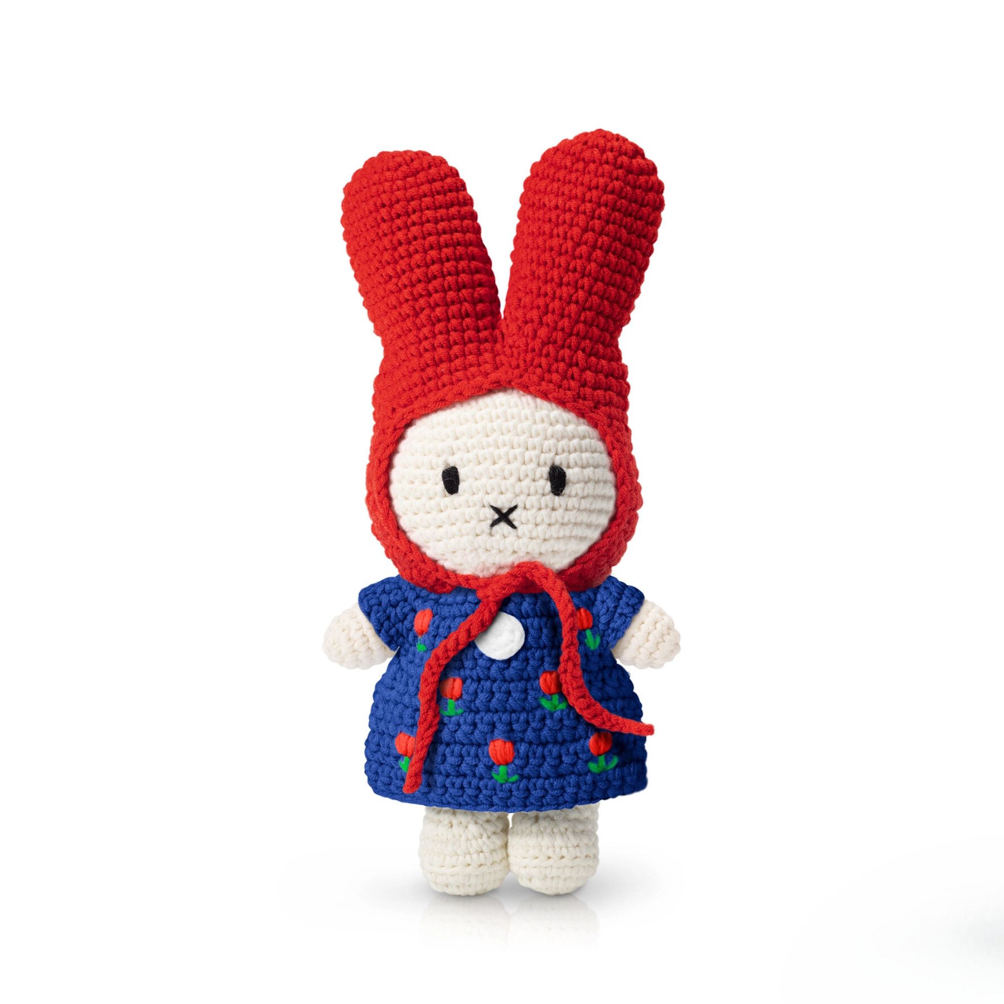 Close-up of handmade crochet bunny doll wearing a red bonnet and deep blue dress with embroidered red tulips — soft and detailed plush toy for collectors or gifting.
