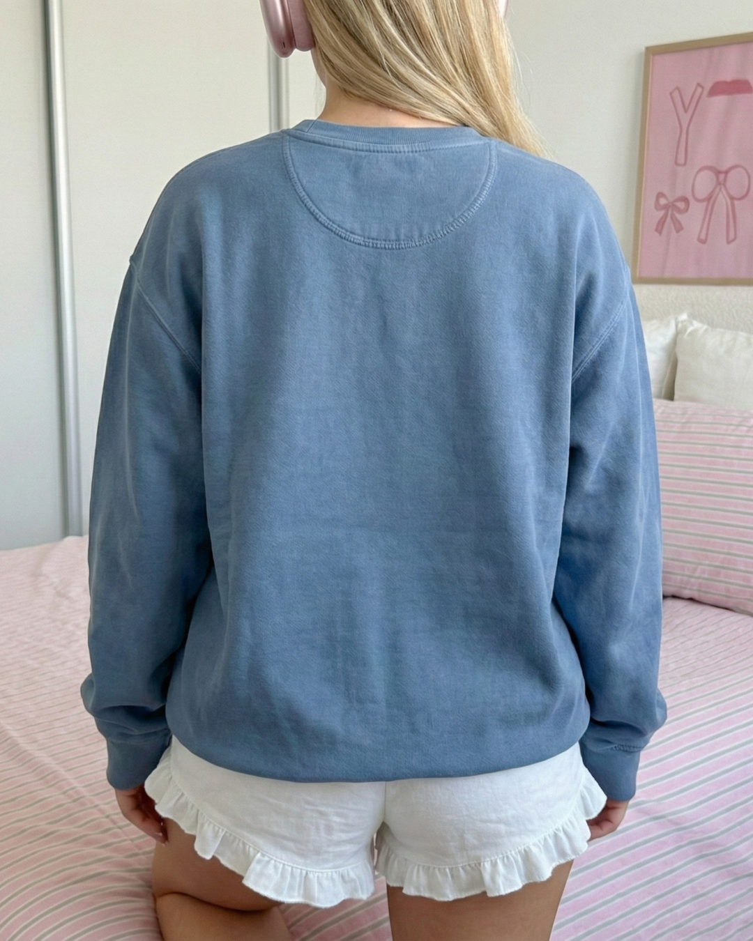 Back view of a dusty blue crewneck sweatshirt with a relaxed unisex fit and soft fleece fabric