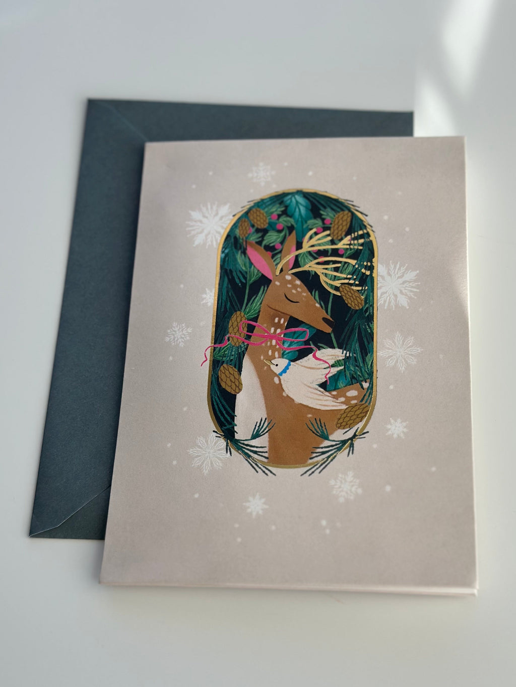Festive deer Christmas card with gold foil and spruce envelope, snowflake accents.
