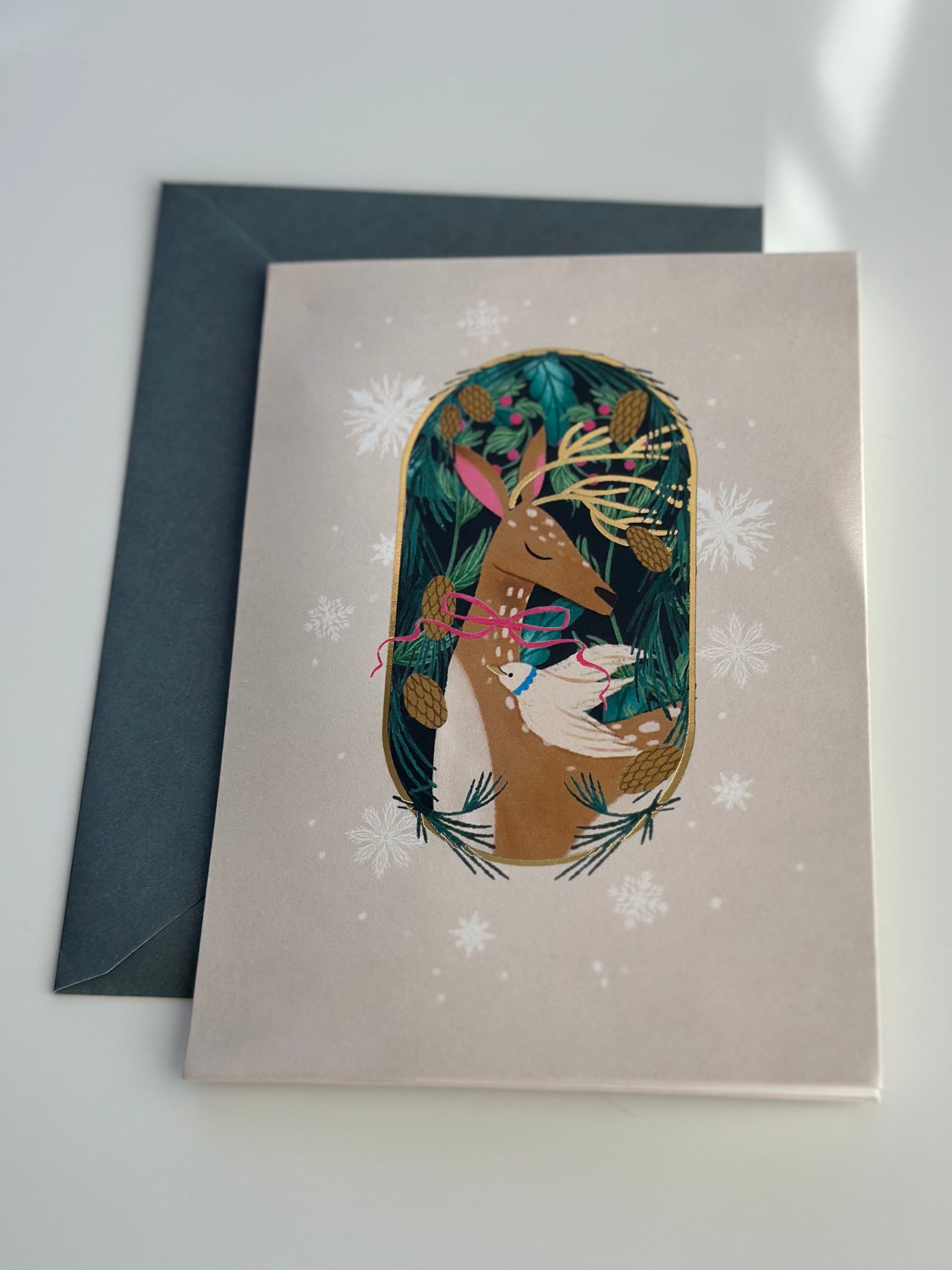 Festive deer Christmas card with gold foil and spruce envelope, snowflake accents.