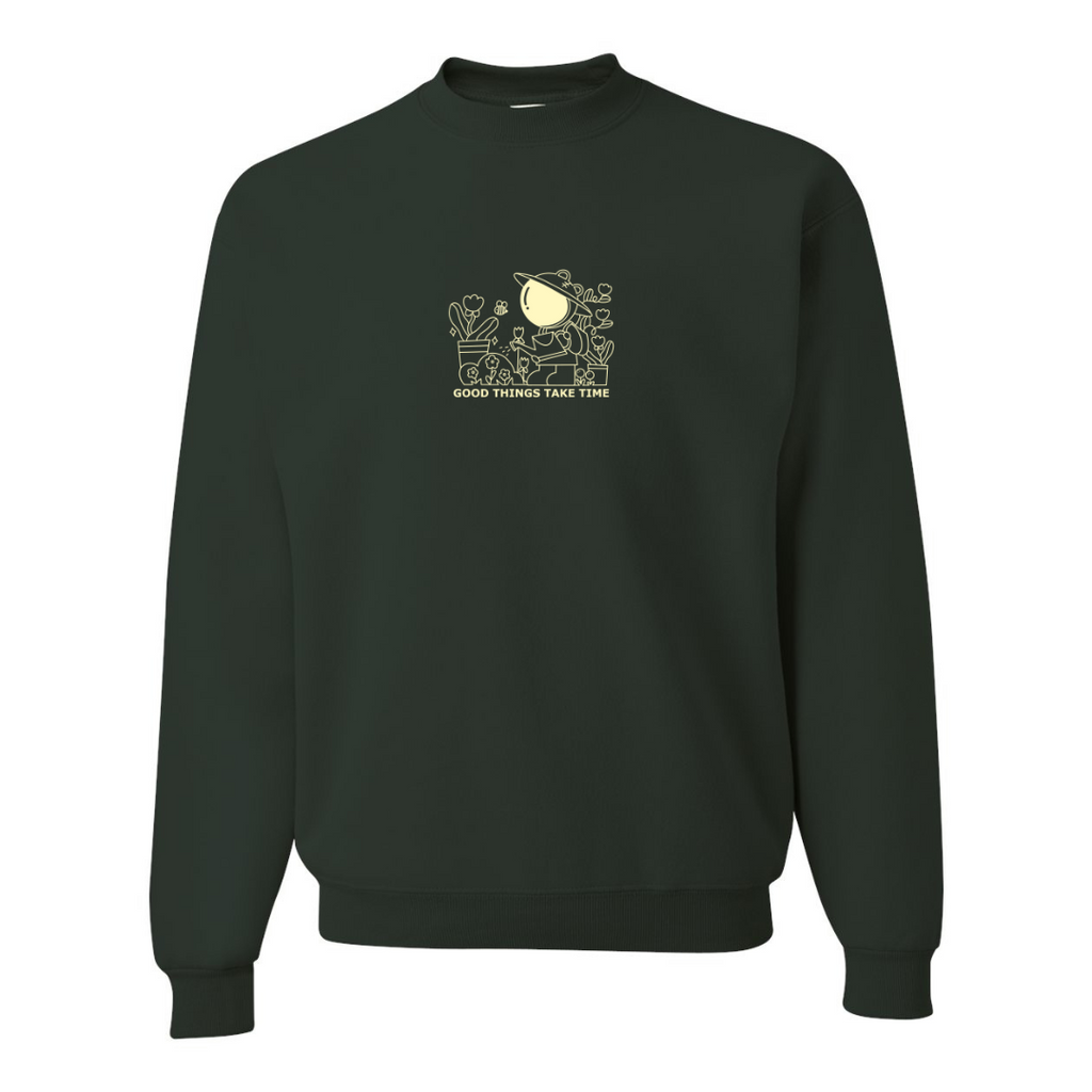 Flat lay of forest green crewneck sweatshirt with ‘Good things take time’ embroidered gardening design on front
