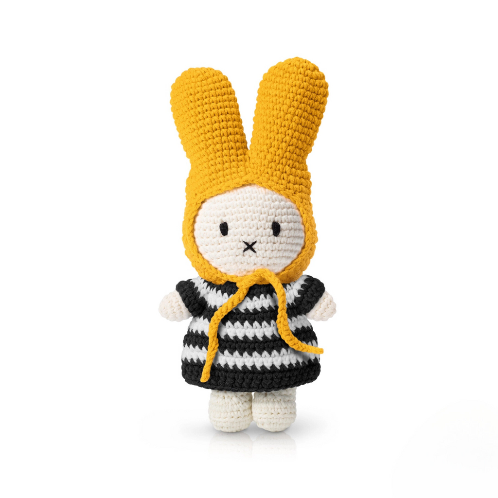Striped crochet bunny doll with yellow bonnet and black-and-white dress — a minimalist yet playful plush toy for soft toy collectors or decor lovers.