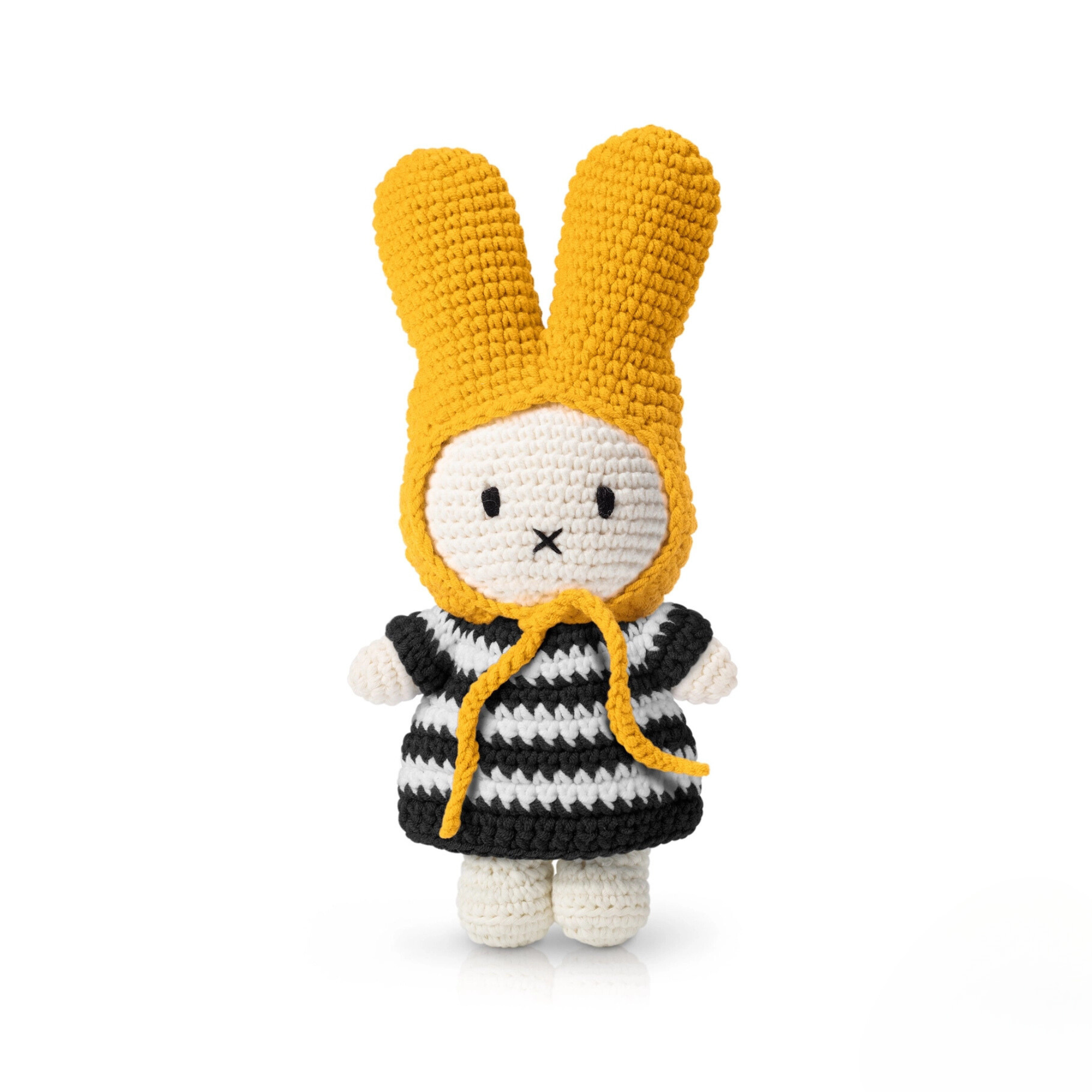 Striped crochet bunny doll with yellow bonnet and black-and-white dress — a minimalist yet playful plush toy for soft toy collectors or decor lovers.