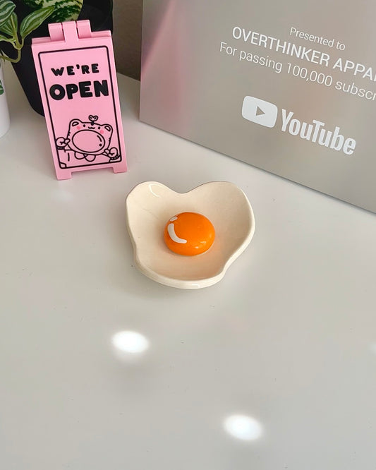 Cute ceramic egg trinket tray with glossy orange yolk and smooth finish