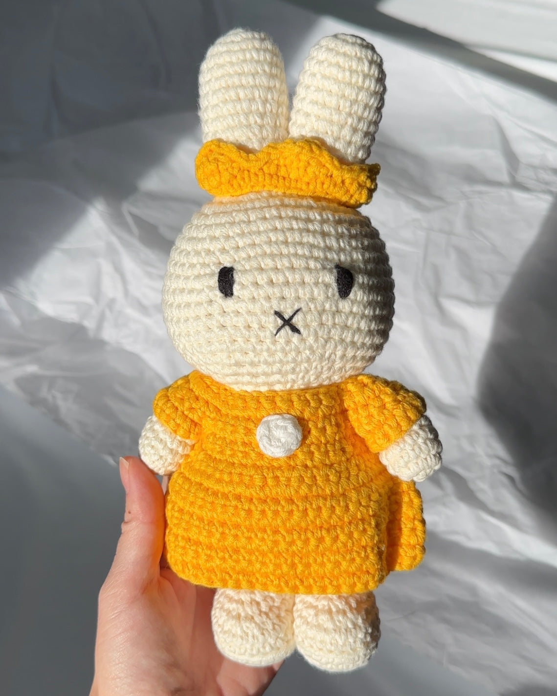 Handmade Miffy crochet plush wearing yellow dress and crown