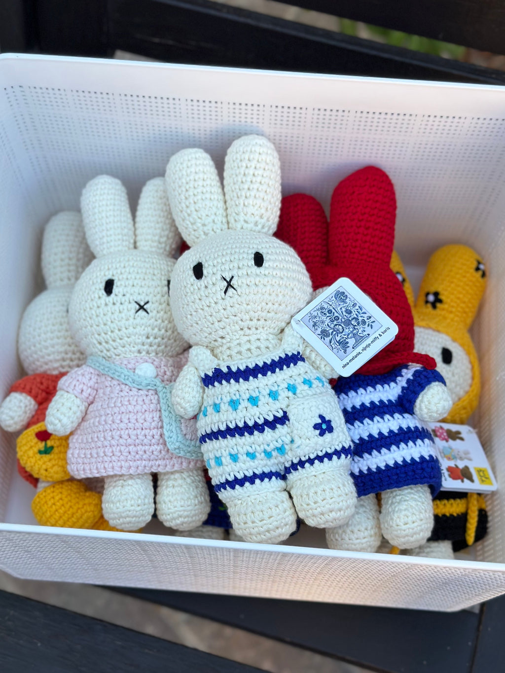 Handmade Delft blue Miffy crochet plush displayed in a basket with other collectible Just Dutch crochet Miffy dolls.