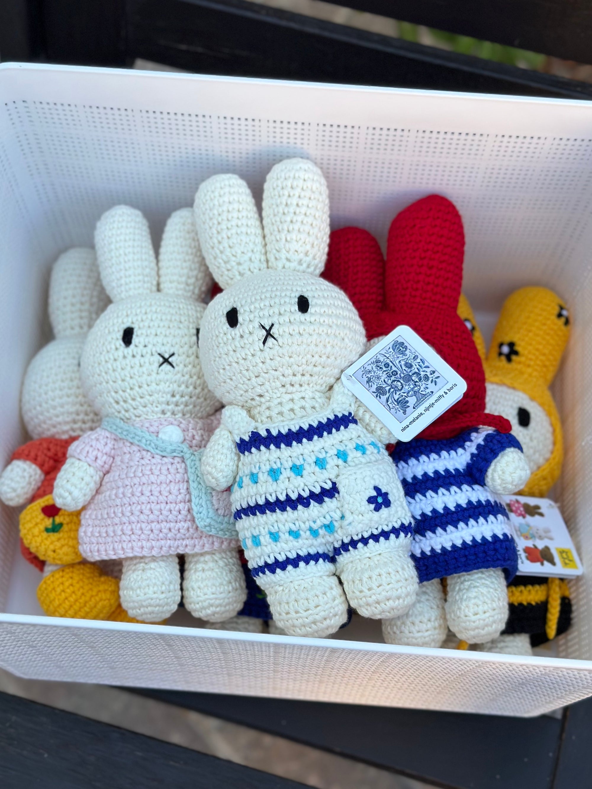 Handmade Delft blue Miffy crochet plush displayed in a basket with other collectible Just Dutch crochet Miffy dolls.