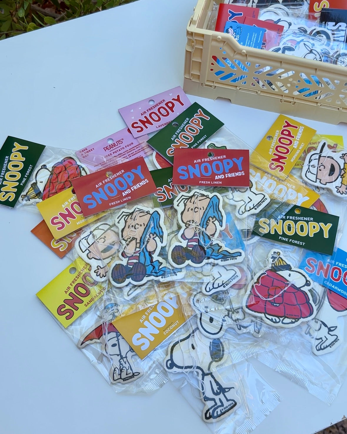 Flat lay of assorted Snoopy and Linus air fresheners, featuring Linus Fresh Linen scent in the center.