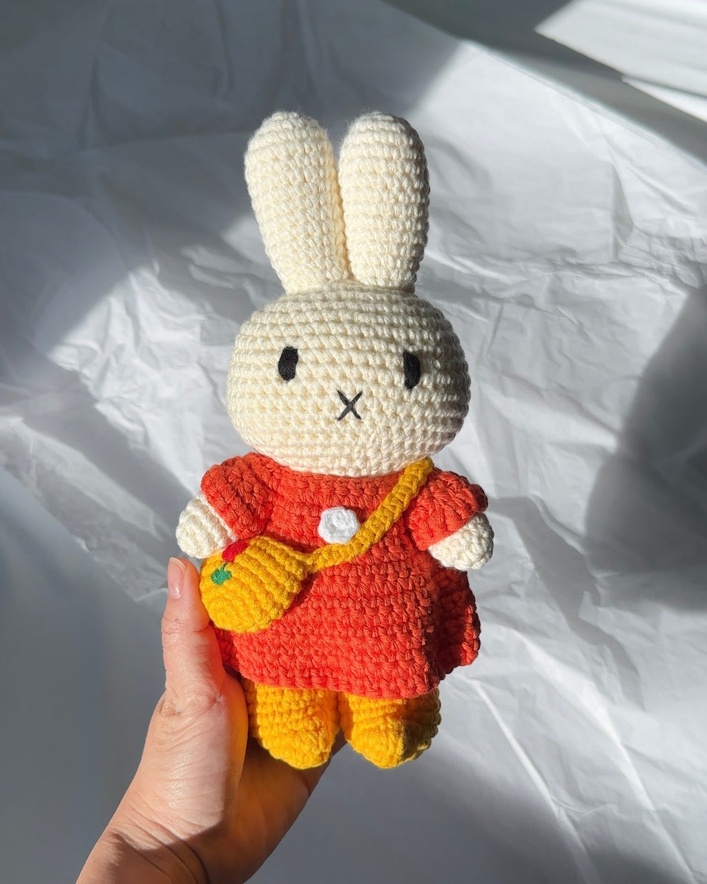 Handmade Miffy crochet plush with red dress, tulip bag, and yellow shoes