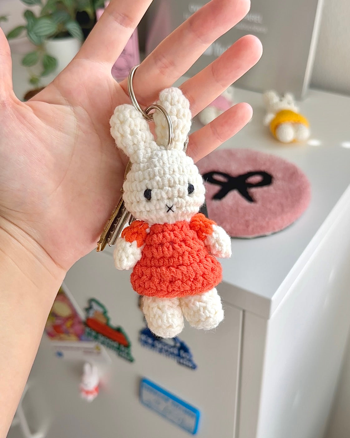 Handmade Miffy plush keychain in orange used as kawaii bag accessory