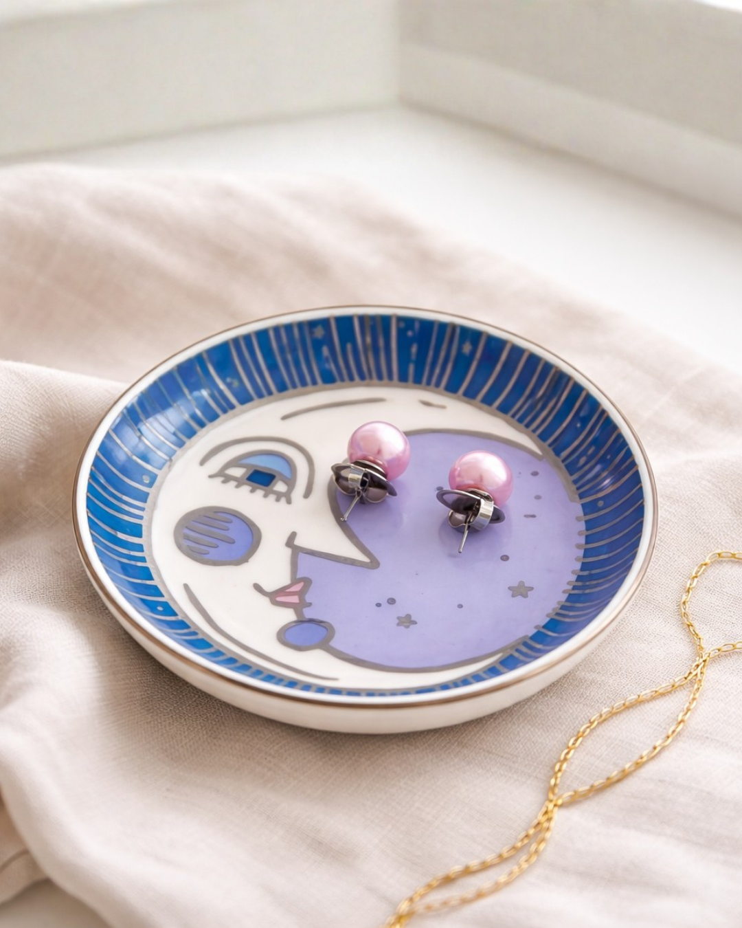 Moon face jewelry dish with pink pearl earrings on linen fabric, celestial trinket tray for rings earrings and small jewelry storage