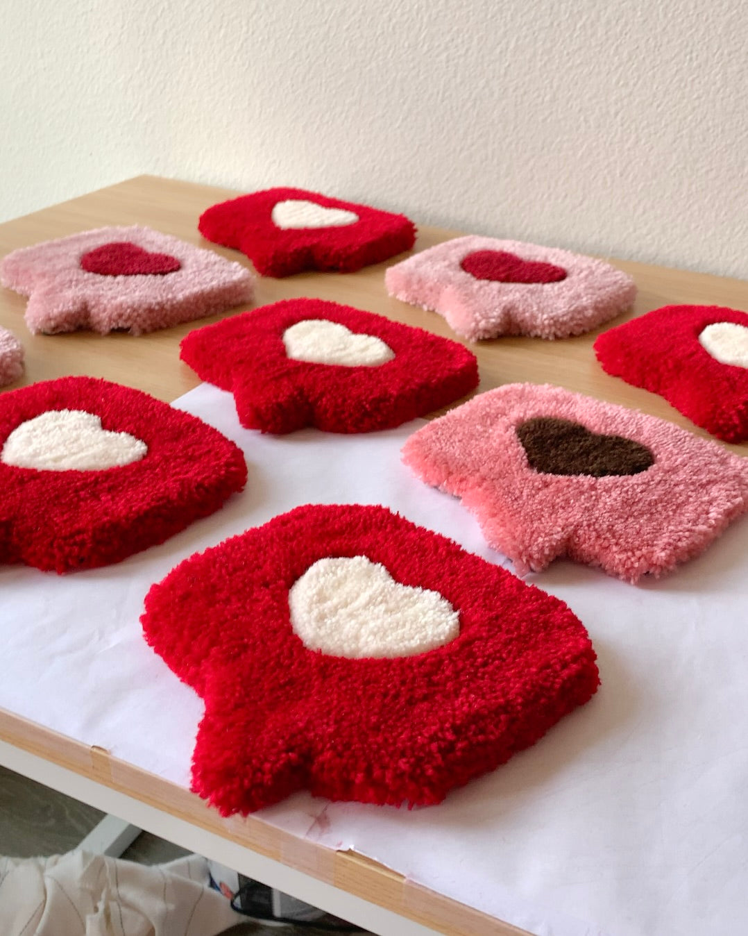 Close-up of a plush tufted heart mug rug with raised heart design, soft handmade coaster used as a mug rug or jewelry mat.