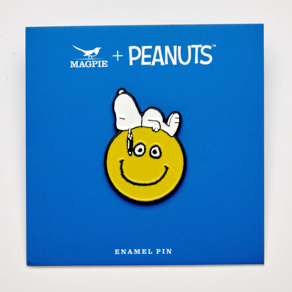 Snoopy enamel pin lounging on smiley face – “Nice Day” retro design