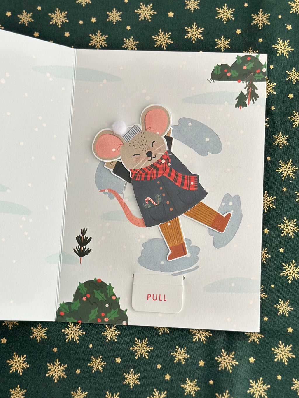 Inside of card showing the mouse mid-movement near mistletoe, pull tab visible at bottom.