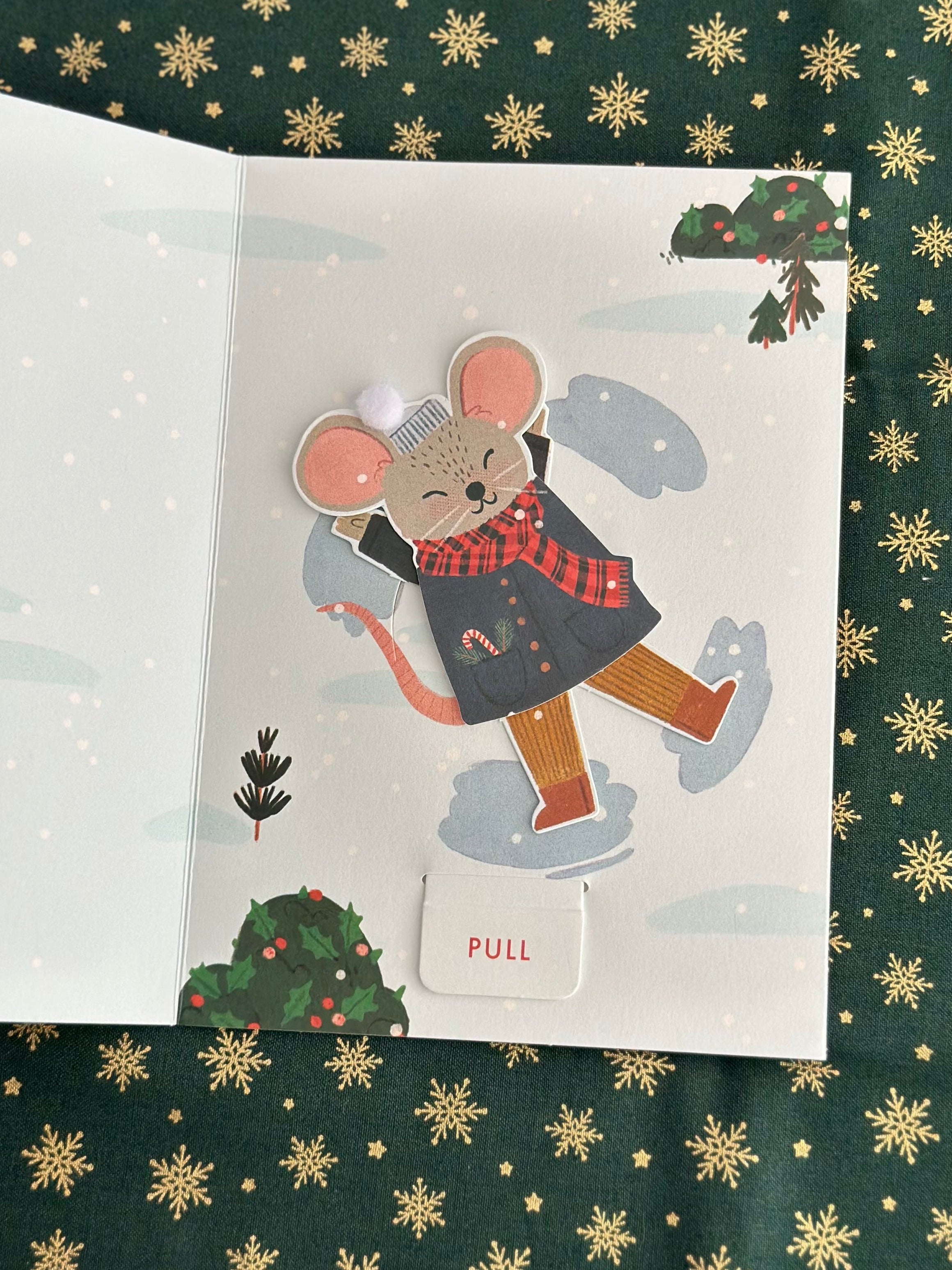 Inside of card showing the mouse mid-movement near mistletoe, pull tab visible at bottom.