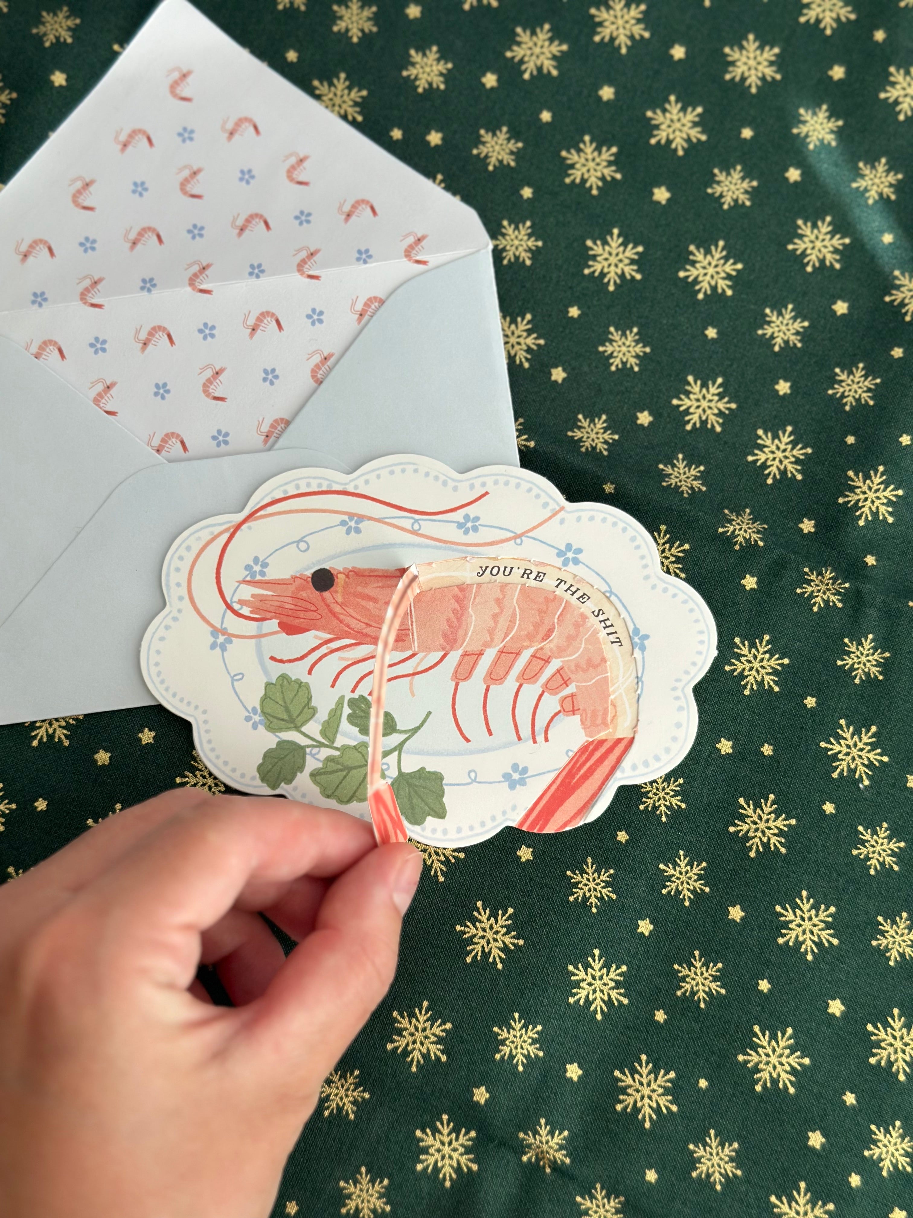 Interactive holiday card that reveals a hidden message when you pull the tail. Thick cardstock, illustrated liner, and playful coastal vibe. Great for office gift exchange, White Elephant, or chef gifts.