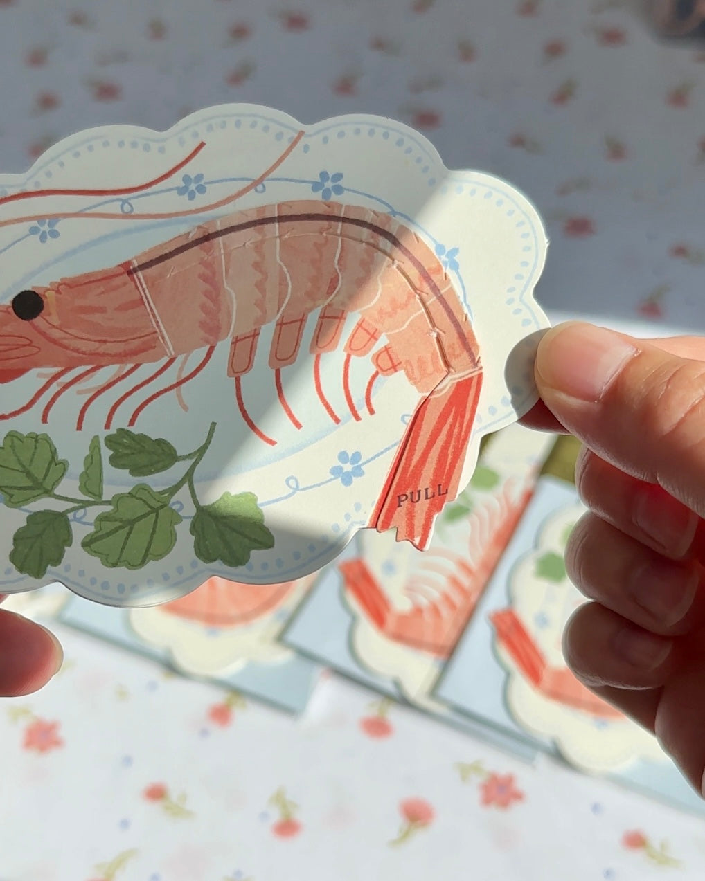 Close-up of shrimp pun greeting card with interactive “Pull” tab.