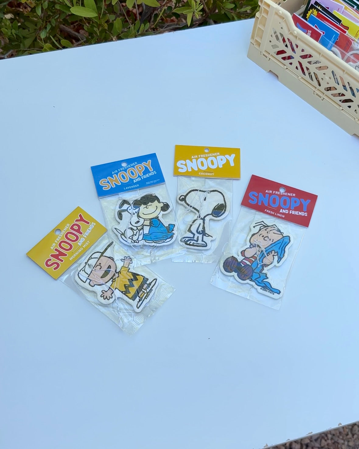 Snoopy-themed air fresheners on a white surface 