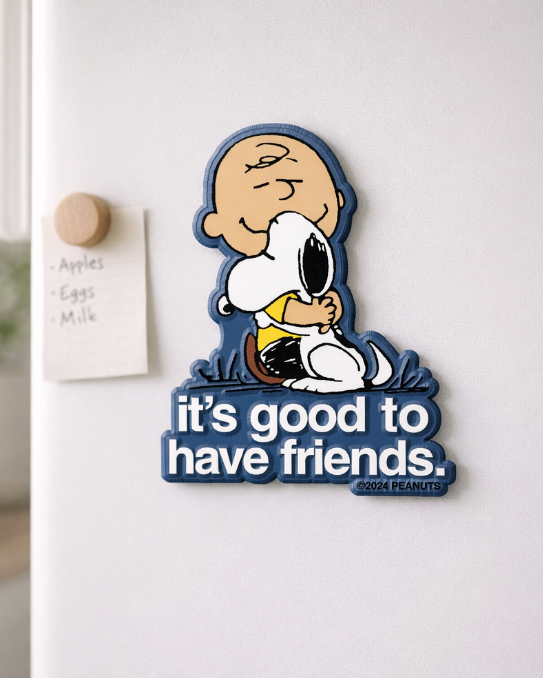 Snoopy hugging Charlie Brown magnet with friendship quote on refrigerator door, cute Peanuts fridge decor.