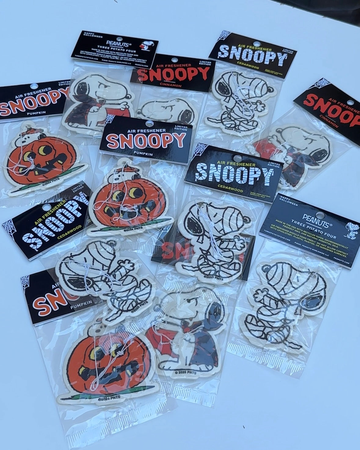 Bundle of Snoopy Halloween air fresheners in multiple scents and designs, from playful pumpkins to spooky mummies and vampires.