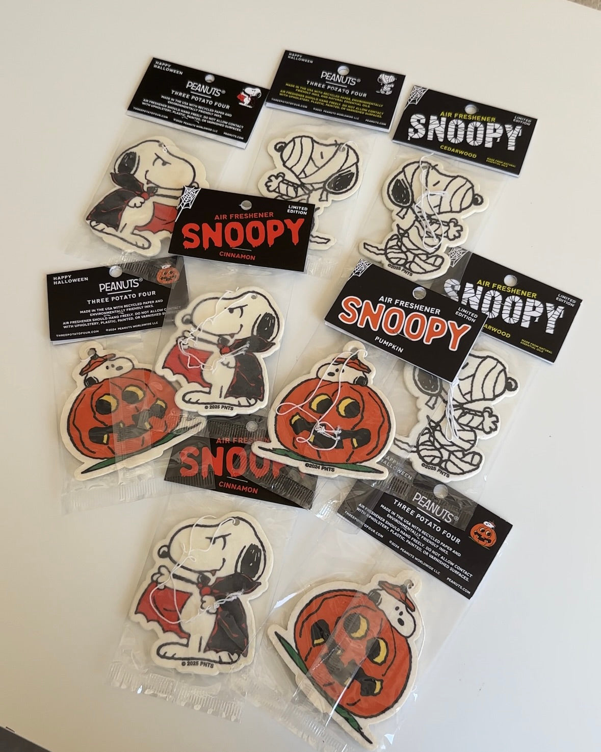 Snoopy Halloween air freshener collection featuring pumpkin, mummy, and vampire designs—perfect for spooky season car decor or as gifts for Peanuts fans.
