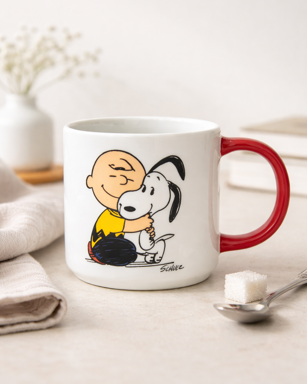 Snoopy Happiness Is a Warm Puppy ceramic mug with red handle featuring Charlie Brown hugging Snoopy, Peanuts coffee mug for cozy mornings