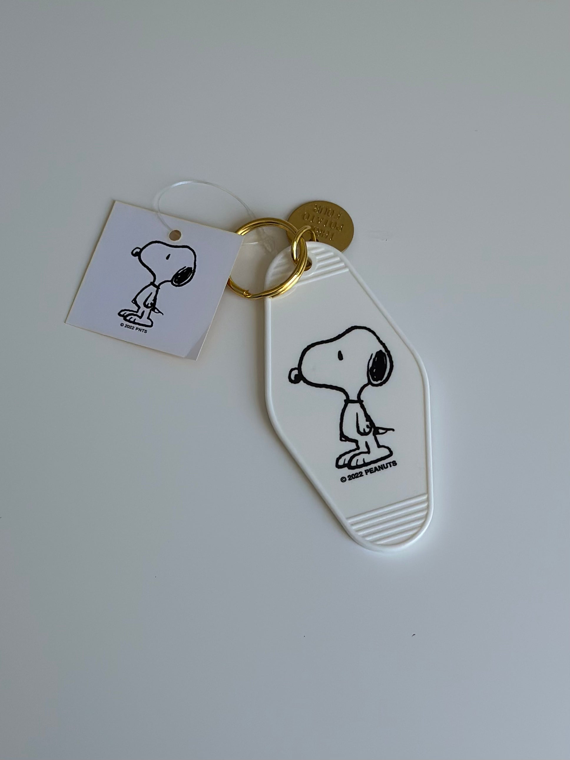 Minimalist Snoopy motel key fob in black-and-white with glossy finish.