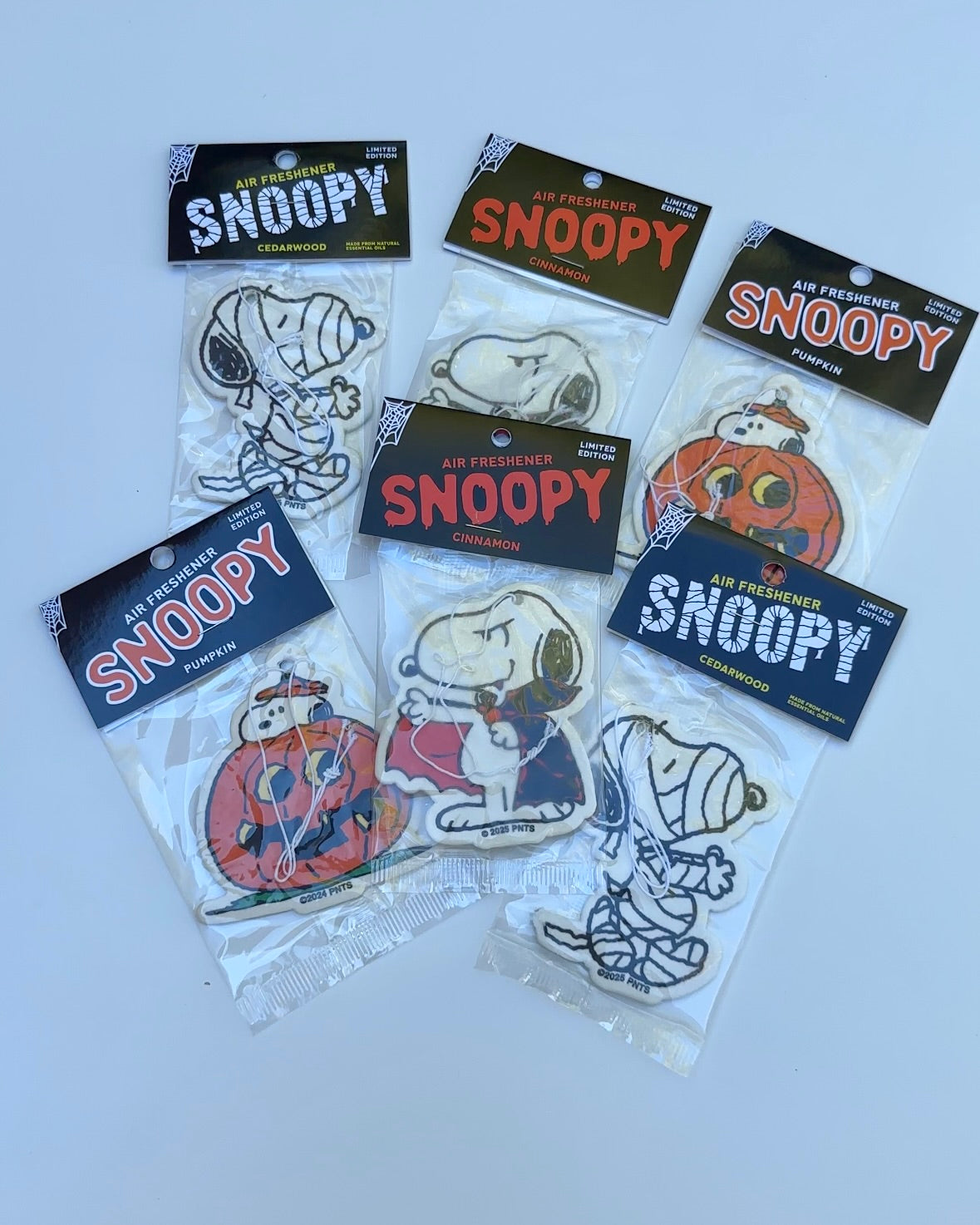 Official Peanuts® Snoopy Halloween air fresheners in fun seasonal designs – Snoopy as a mummy, vampire, and inside a pumpkin. Available in cedarwood, cinnamon, and pumpkin scents. A cute and collectible fall accessory for cars, lockers, and Halloween decor.