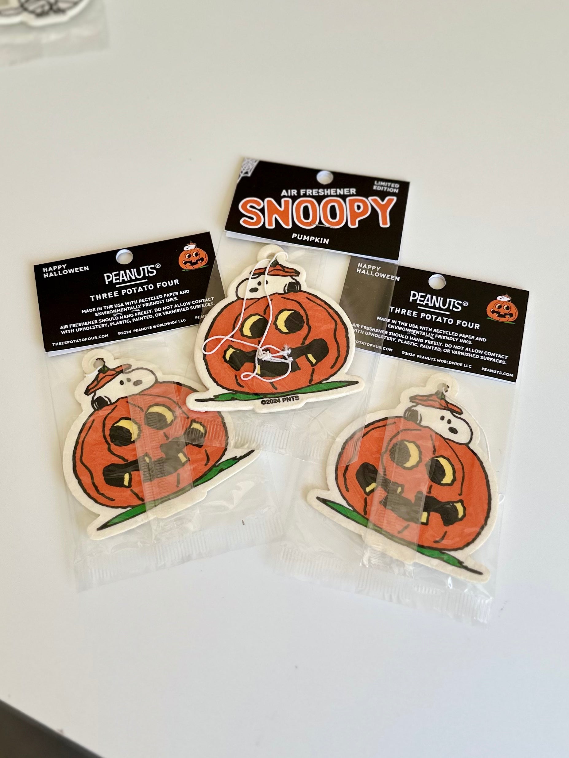 Limited edition Snoopy pumpkin air freshener featuring Snoopy peeking out from inside a carved jack-o’-lantern
