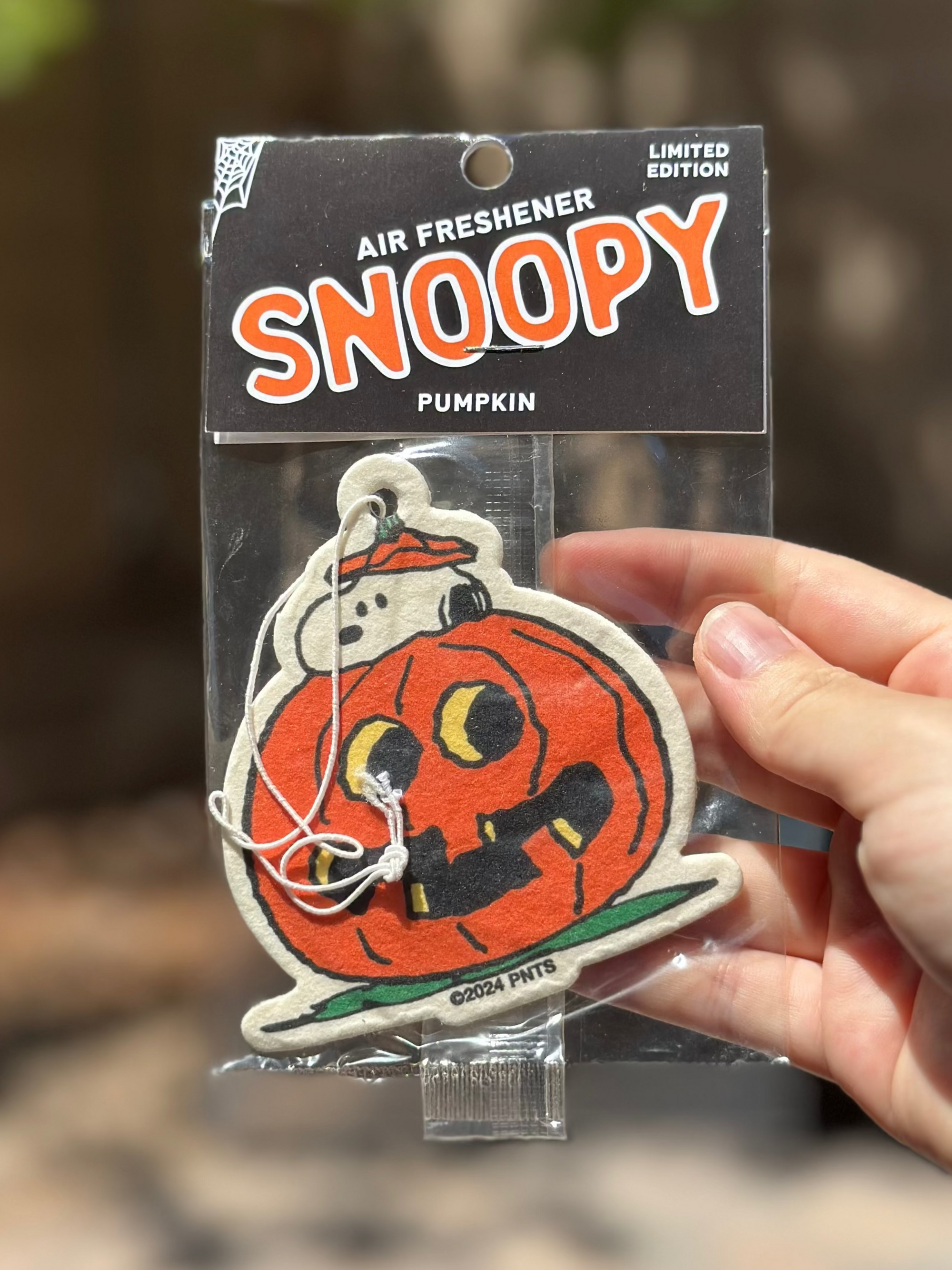 Limited edition Snoopy pumpkin air freshener featuring Snoopy peeking out from inside a carved jack-o’-lantern