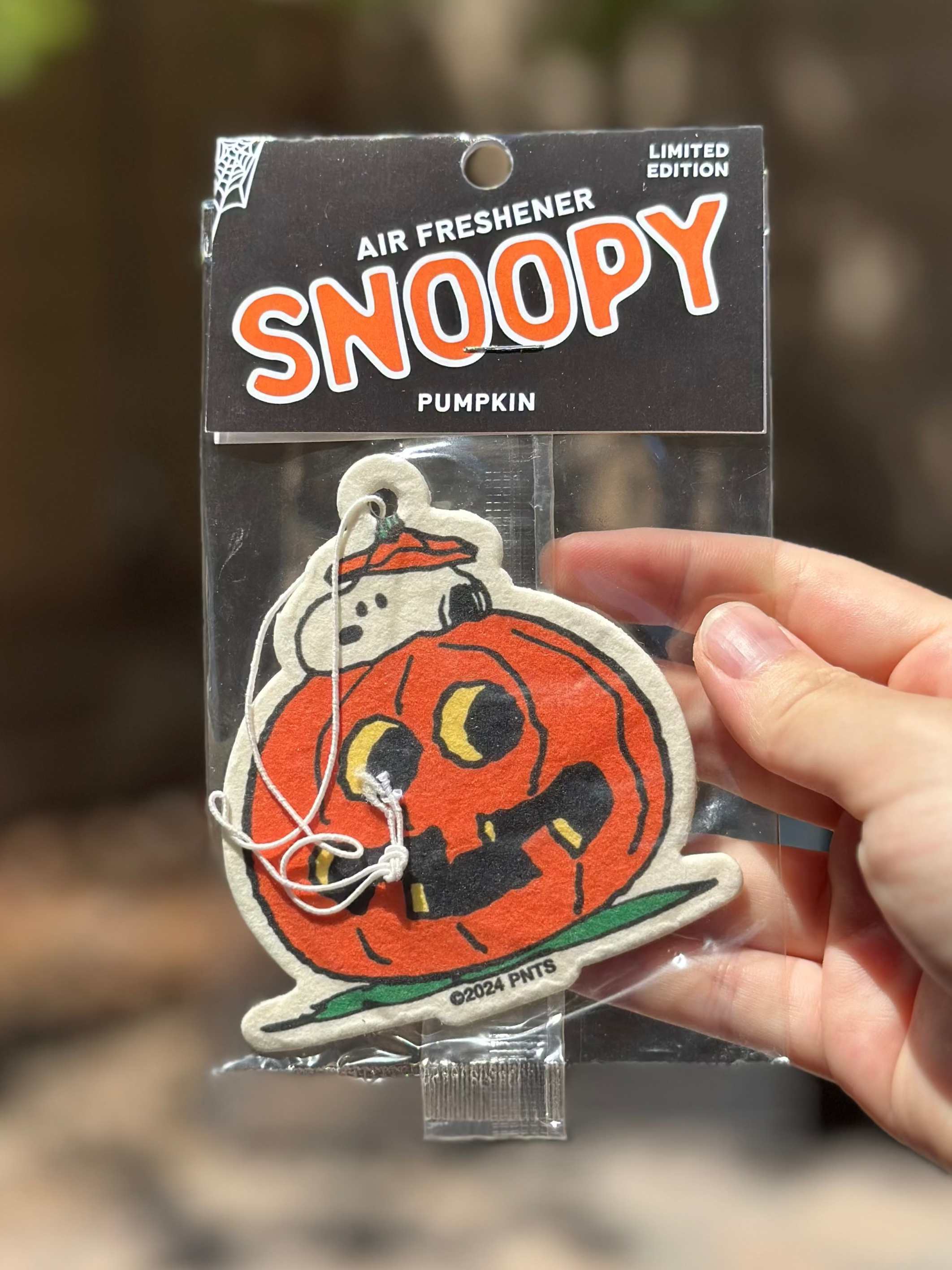 Limited edition Snoopy pumpkin air freshener featuring Snoopy peeking out from inside a carved jack-o’-lantern