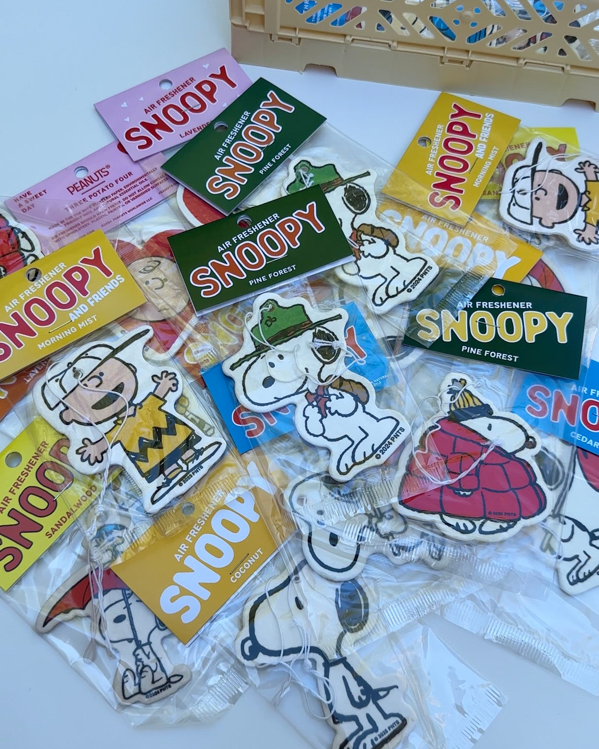 Flat lay of assorted Snoopy and Charlie Brown air fresheners, featuring Scout Snoopy Pine Forest scent in the center.