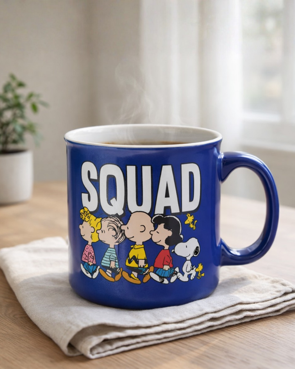 Blue Snoopy Peanuts squad cartoon coffee mug with steam rising from hot coffee on wooden table, novelty cartoon mug for coffee lovers and Peanuts fans
