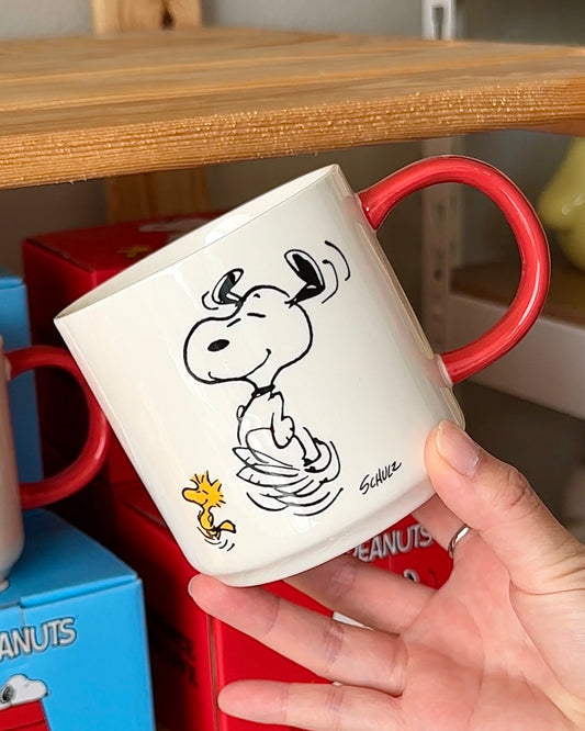 Official Snoopy “To Dance Is To Live” ceramic mug featuring dancing Snoopy and Woodstock with a red handle; cheerful gift-ready Peanuts® coffee cup